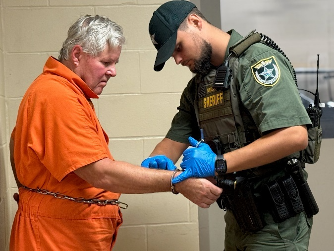  A detention deputy books Kermit Booth at the Sheriff Perry Hall Inmate Detention Facility in Bunnell, Fla., on Friday, Sept. 5, 2025.