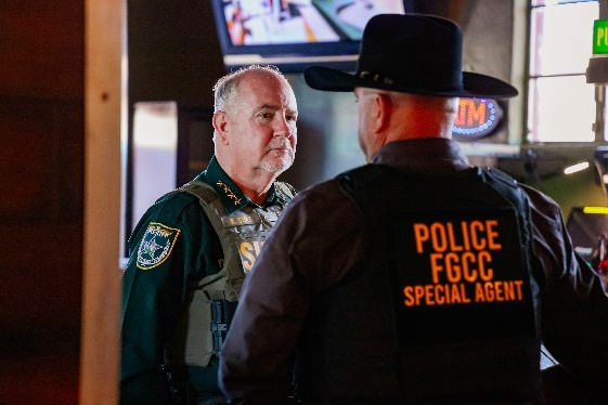 Flagler County Sheriff Rick Staly speaks with a Florida Gaming Control Commission special agent during “Reels of Fortune” undercover operation.