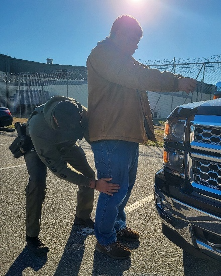 A deputy searches Cameron Terry upon his arrest at the Sheriff Perry Hall Inmate Detention Facility.