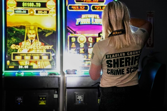  Crime Scene Investigator Caitlin Butler photographs illegal gaming machines at Crossroads Tavern