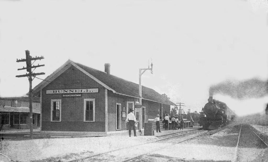 Bunnell-Depot-with-3-30-pm-train-coming-to-pick-up-passengers-c1912-or-latergrey