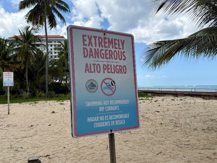 A sign on Condado Beach in Suan Juan, Puerto Rico, warns of rip currents.