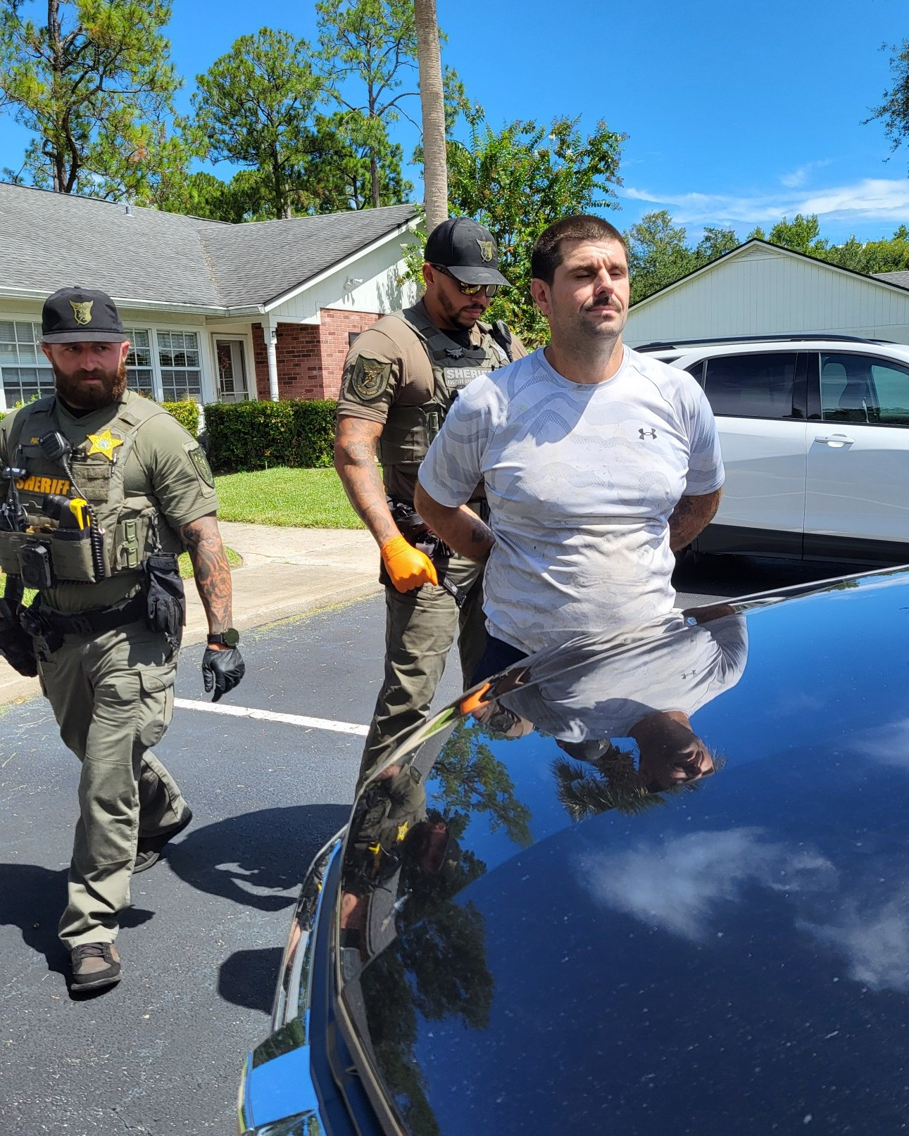 Deputies arrest Christopher Raymond, right, in Palm Coast, Fla., Tuesday, Sep. 1, 2026.